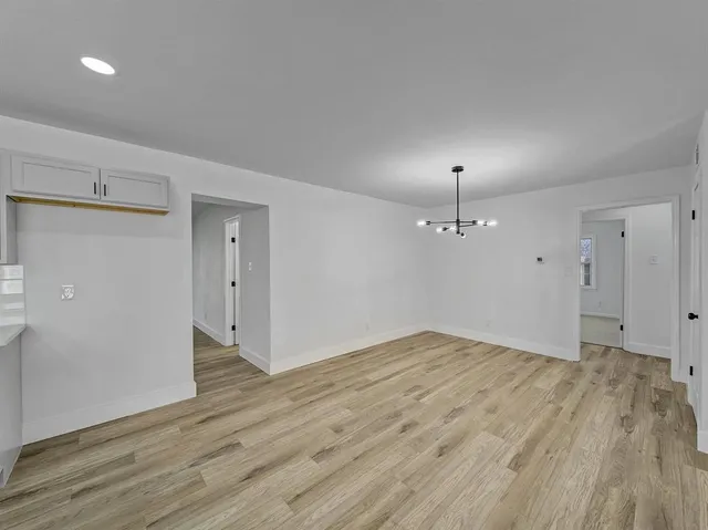 a view of an empty room and wooden floor