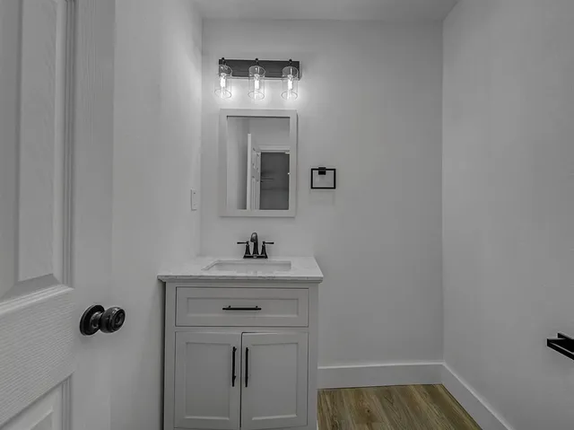 a bathroom with a sink and mirror