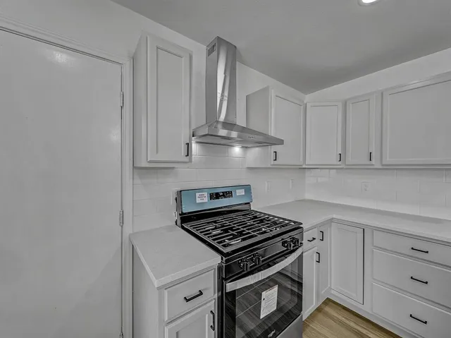 a stove top oven sitting inside of a kitchen
