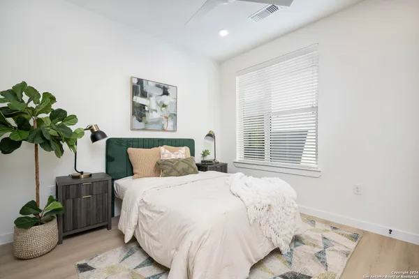 a bedroom with a large bed and a window