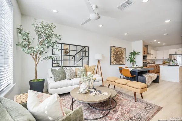 a kitchen with stainless steel appliances a counter space a sink a stove and cabinets