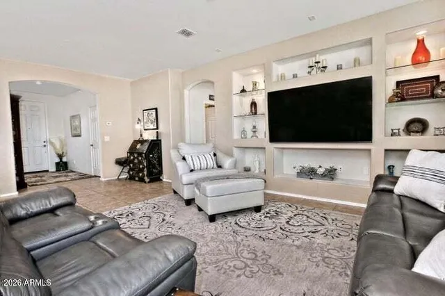 a living room with furniture and a flat screen tv