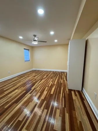 wooden floor in a hall with an empty room