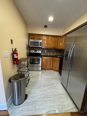 a kitchen with a refrigerator and a sink