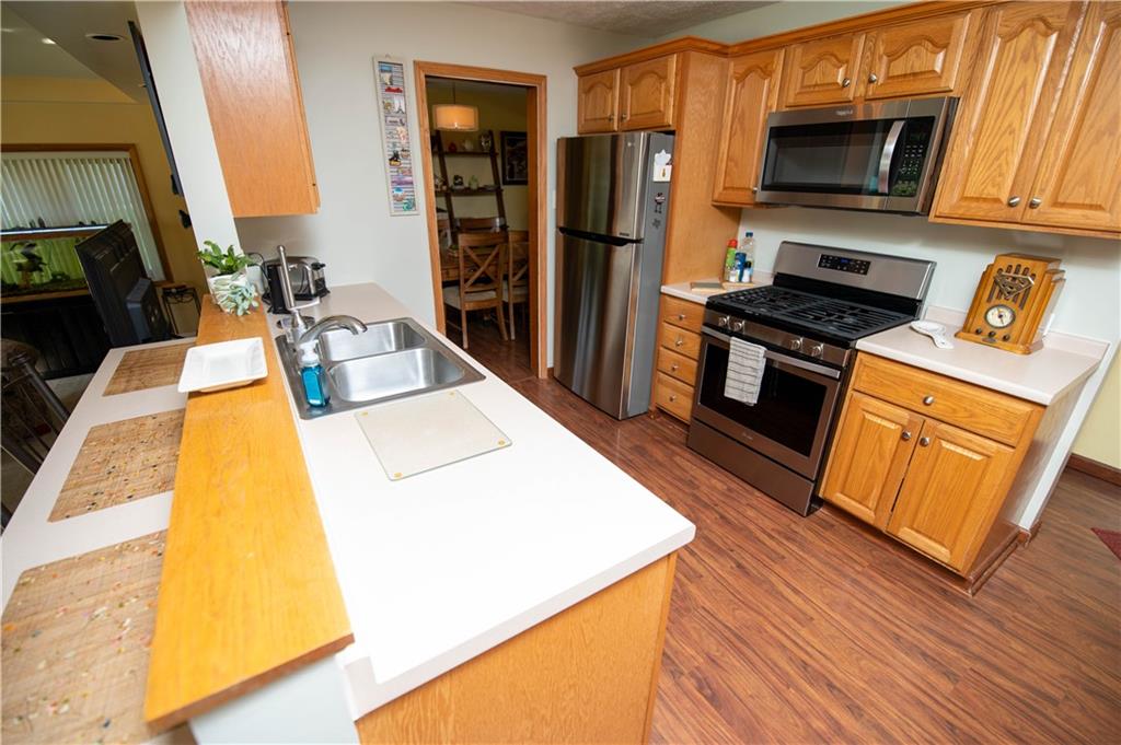 123 Dalecrest Road Verona, PA 15147 - Photo 11 of 25 a kitchen with stainless steel appliances a stove top oven a sink and a refrigerator