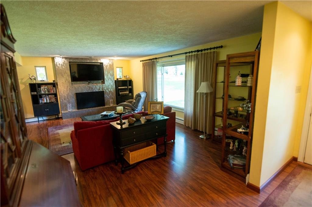 123 Dalecrest Road Verona, PA 15147 - Photo 6 of 25 a living room with furniture a flat screen tv and a fireplace