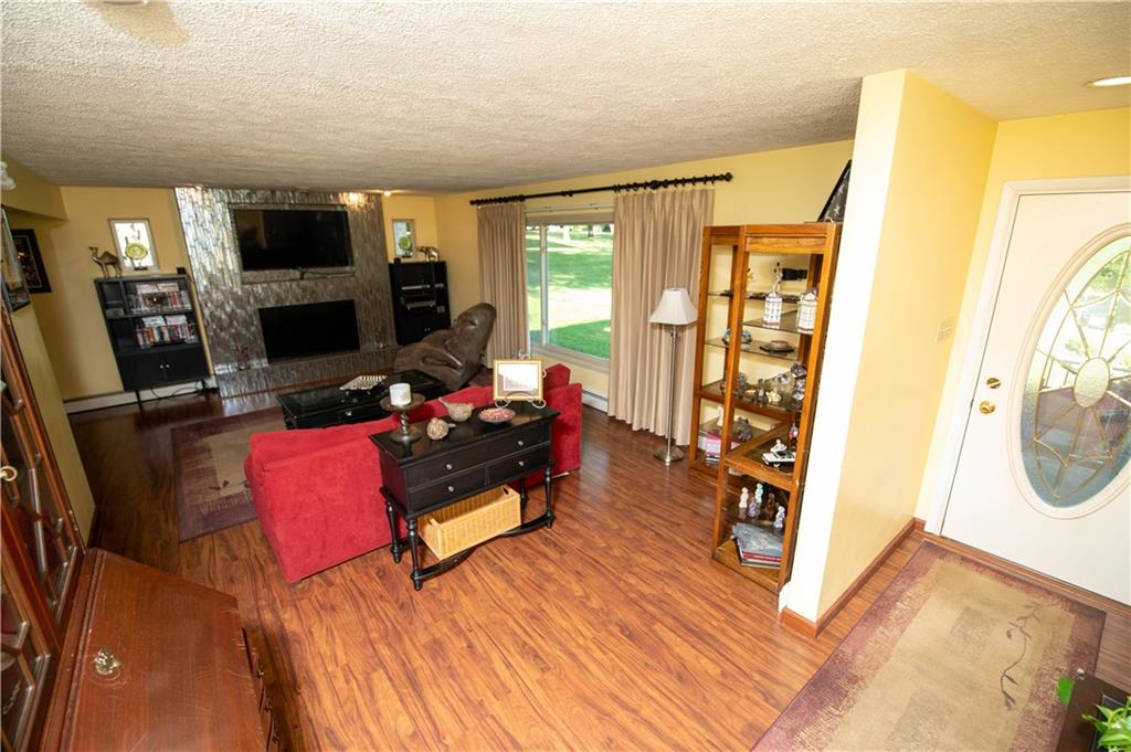 123 Dalecrest Road Verona, PA 15147 - Photo 7 of 25 a living room with furniture a flat screen tv and a fireplace