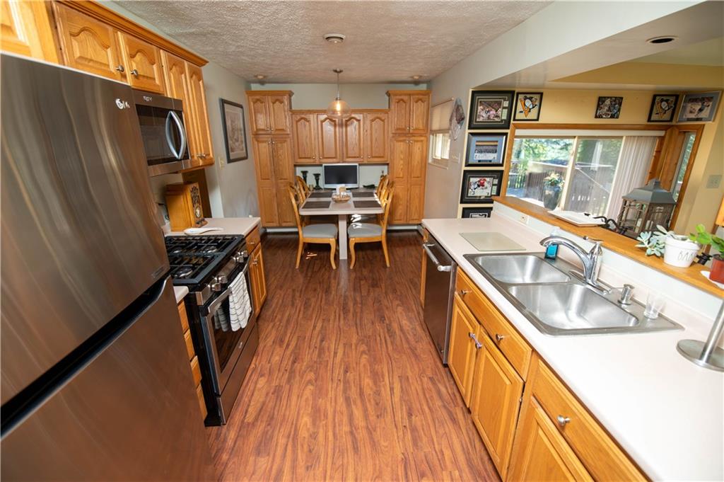 123 Dalecrest Road Verona, PA 15147 - Photo 10 of 25 a view of a kitchen with furniture and wooden floor