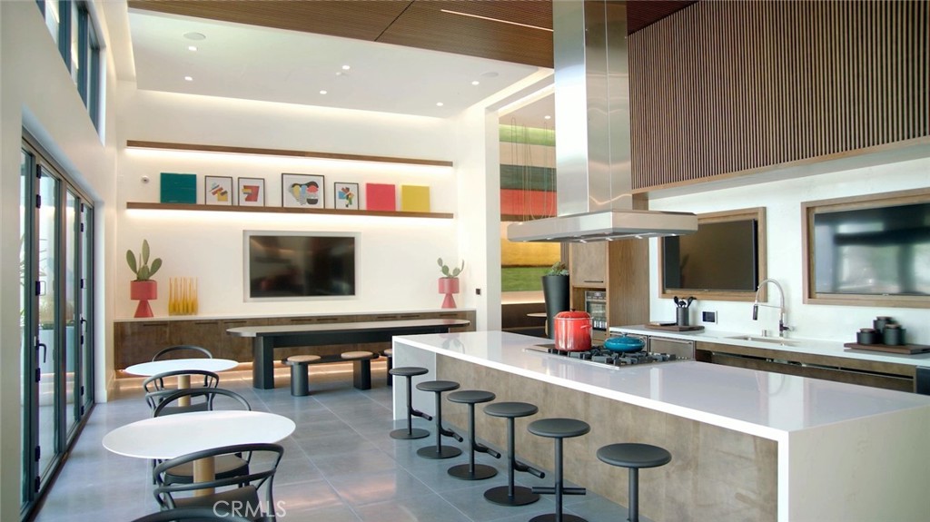 19525 Nordhoff Street, Unit 25662 Northridge, CA 91324 - Photo 26 of 26 a kitchen with stainless steel appliances kitchen island granite countertop a table and chairs in it