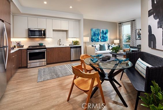 19525 Nordhoff Street, Unit 25662 Northridge, CA 91324 - Photo 10 of 26 a kitchen with a dining table chairs and refrigerator