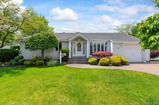 a front view of house with yard and green space