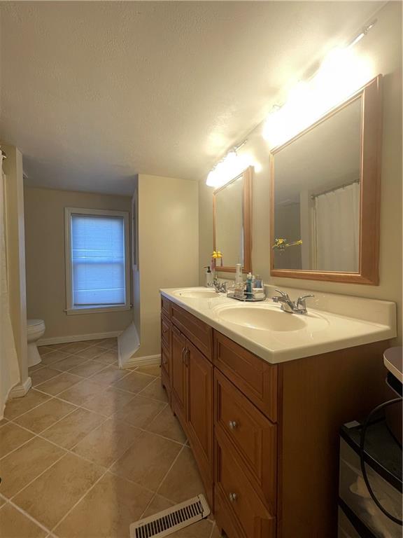 69 Hewitt Avenue Washington, PA 15301 - Photo 15 of 27 a bathroom with a sink and a mirror