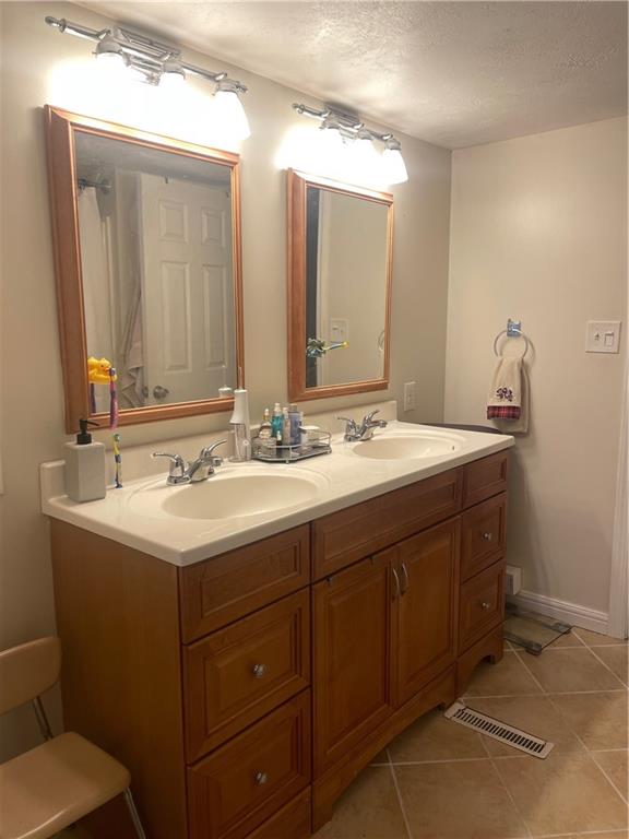 69 Hewitt Avenue Washington, PA 15301 - Photo 18 of 27 a bathroom with a sink and a mirror