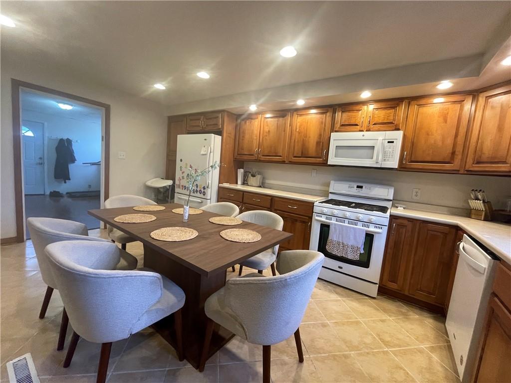 69 Hewitt Avenue Washington, PA 15301 - Photo 24 of 27 a kitchen with kitchen island a stove a table and chairs