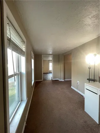 a view of a livingroom and a fireplace