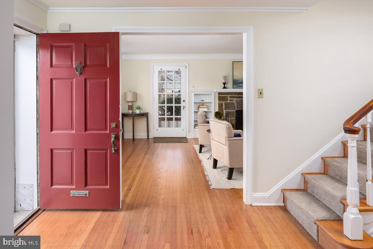 567 Manor Road Wynnewood, PA 19096 - Photo 3 of 34 a hallway with wooden floor electronic appliances and stairs