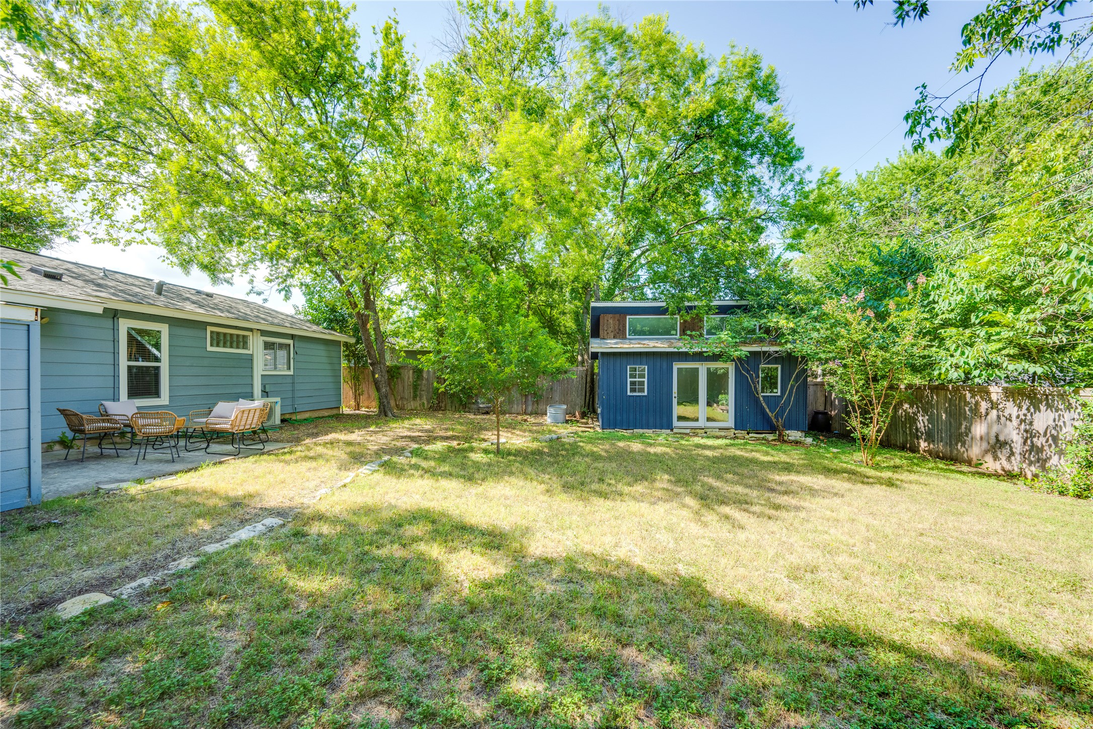 5300 Halmark Drive Austin, TX 78723 - Photo 32 of 40 A spacious, verdant yard invites outdoor activities, complemented by a charming patio ideal for alfresco relaxation.