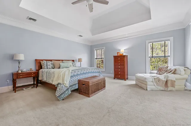 a spacious bedroom with a bed and a couch