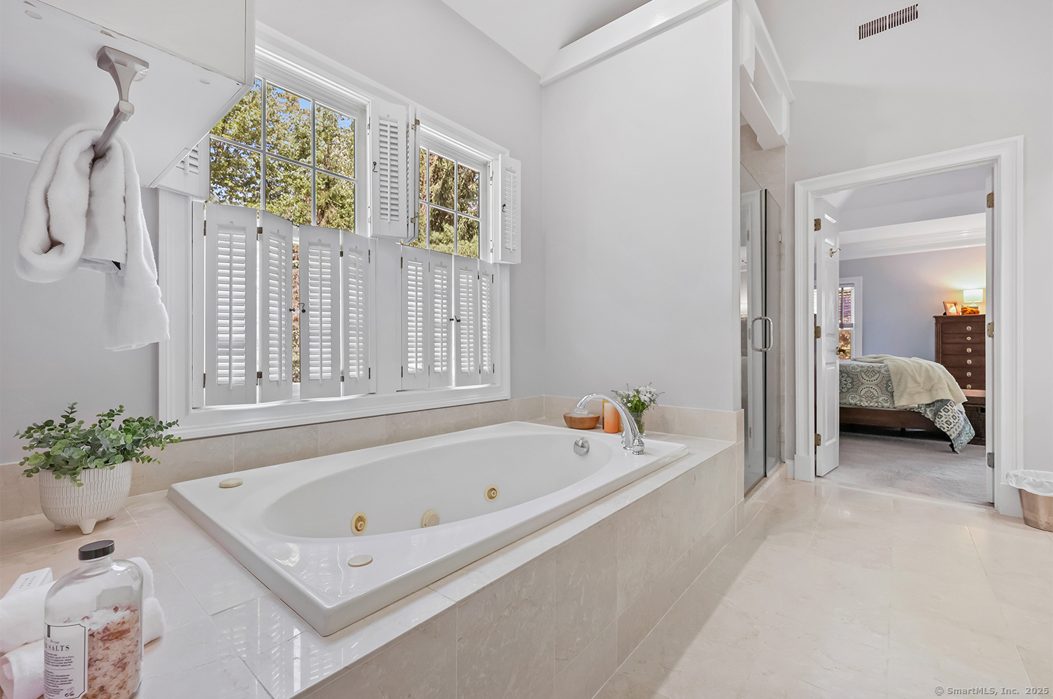 305 South Gate Lane Fairfield, CT 06890 - Photo 19 of 40 a bathroom with a tub sink and mirror