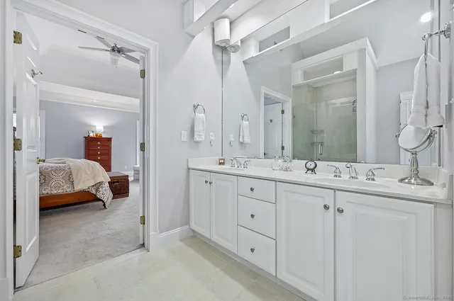 a en suite bathroom with double sink and a mirror