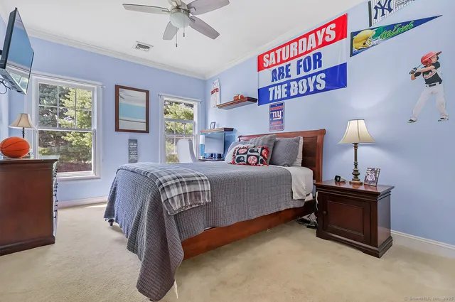 a bedroom with a bed and a chandelier