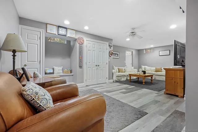 a living room with furniture and a wooden floor