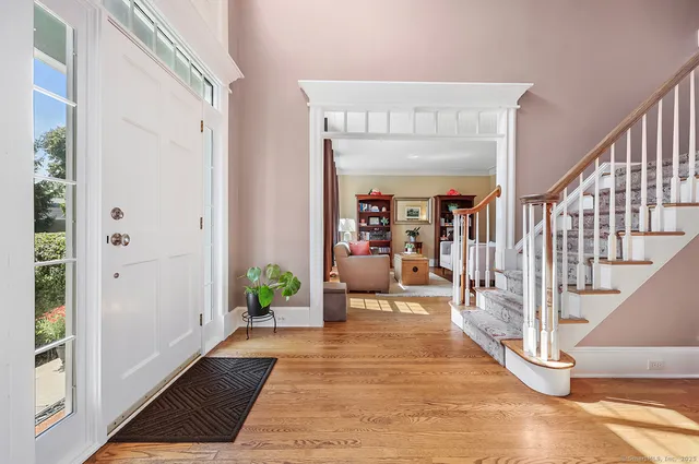 a hallway with wooden floor and furniture