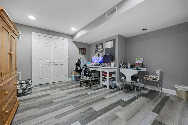 a living room with furniture a rug and a flat screen tv