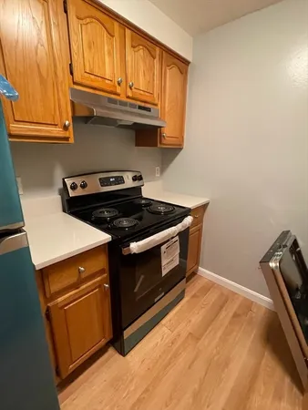 a stove top oven sitting inside of a kitchen