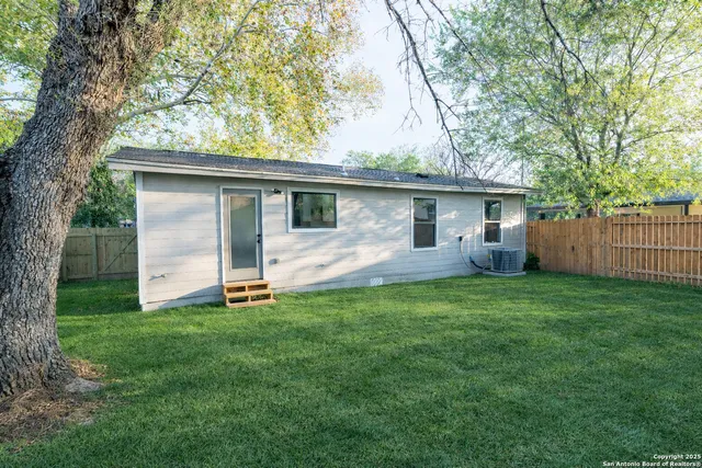 a view of a backyard with large trees