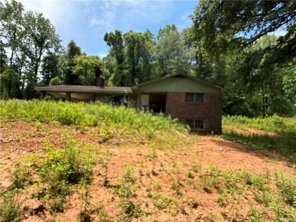 5075 Karr Road Cumming, GA 30040 - Photo 7 of 38 a view of a large garden with plants and a bench