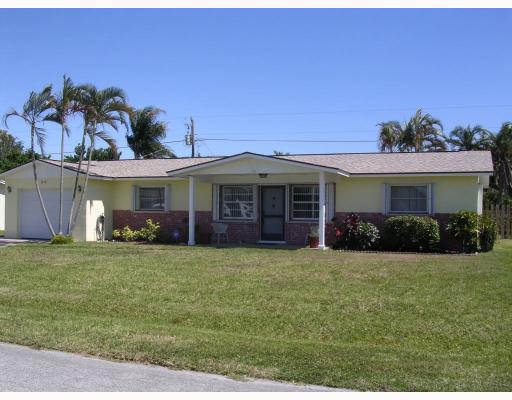 1754 Southeast Lafayette Street Stuart, FL 34997 - Photo 2 of 4 a front view of a house with a garden