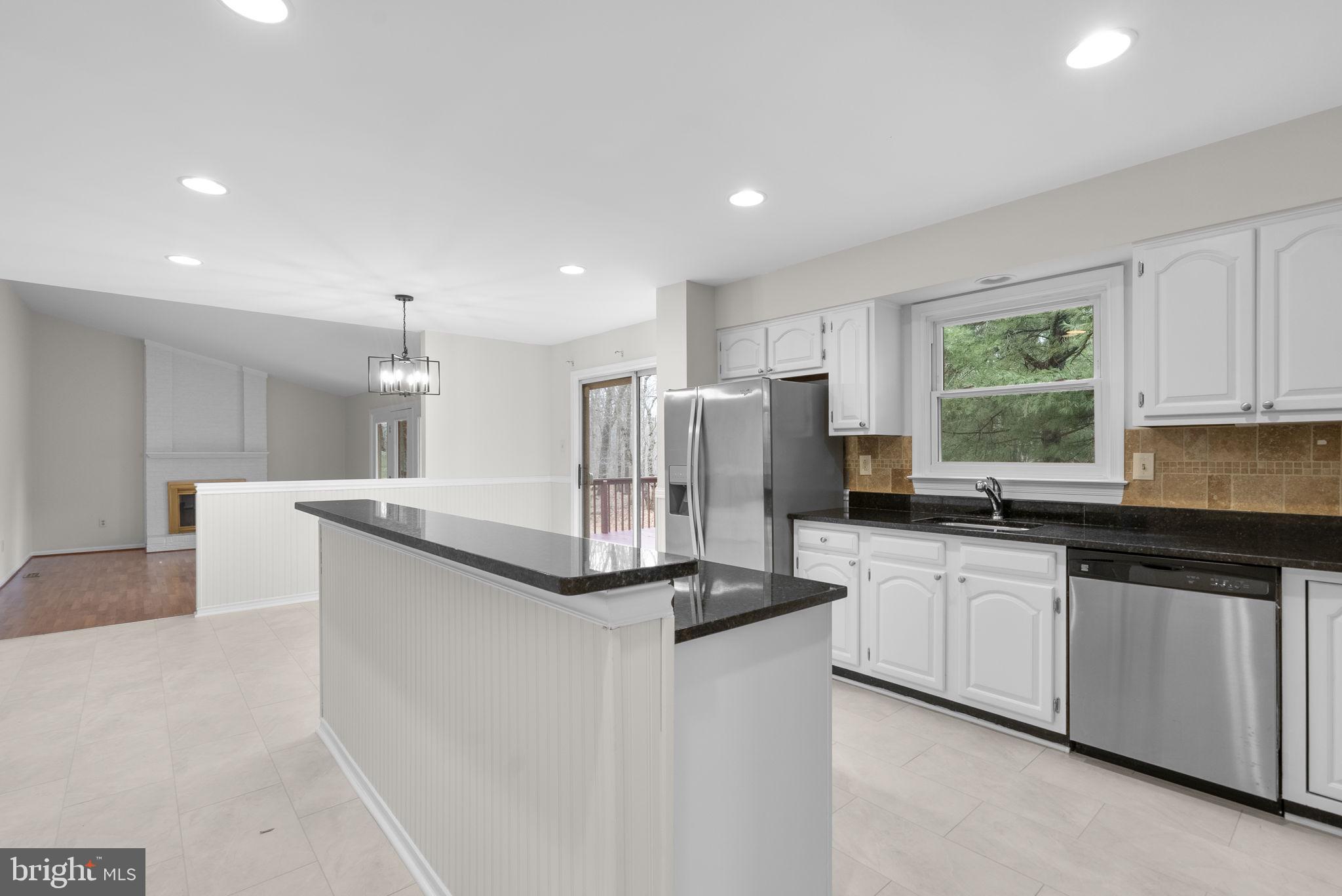 14724 Harvest Lane Silver Spring, MD 20905 - Photo 14 of 53 a kitchen with stainless steel appliances granite countertop a sink and a refrigerator