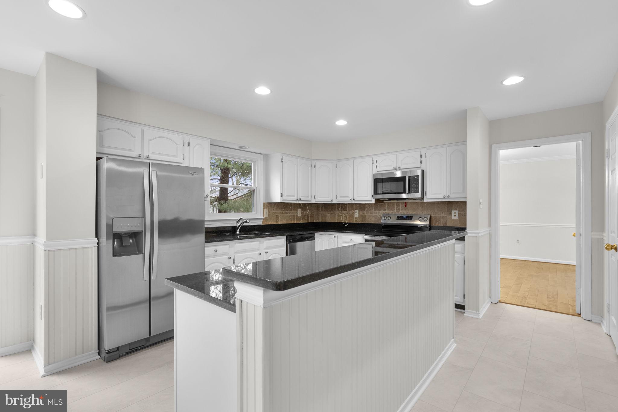 14724 Harvest Lane Silver Spring, MD 20905 - Photo 17 of 53 a kitchen with stainless steel appliances granite countertop a refrigerator and a sink