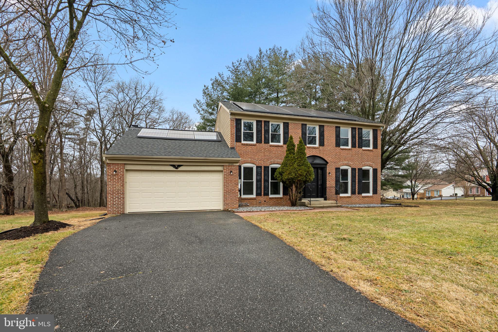 14724 Harvest Lane Silver Spring, MD 20905 - Photo 2 of 53 a front view of a house with a yard and garage