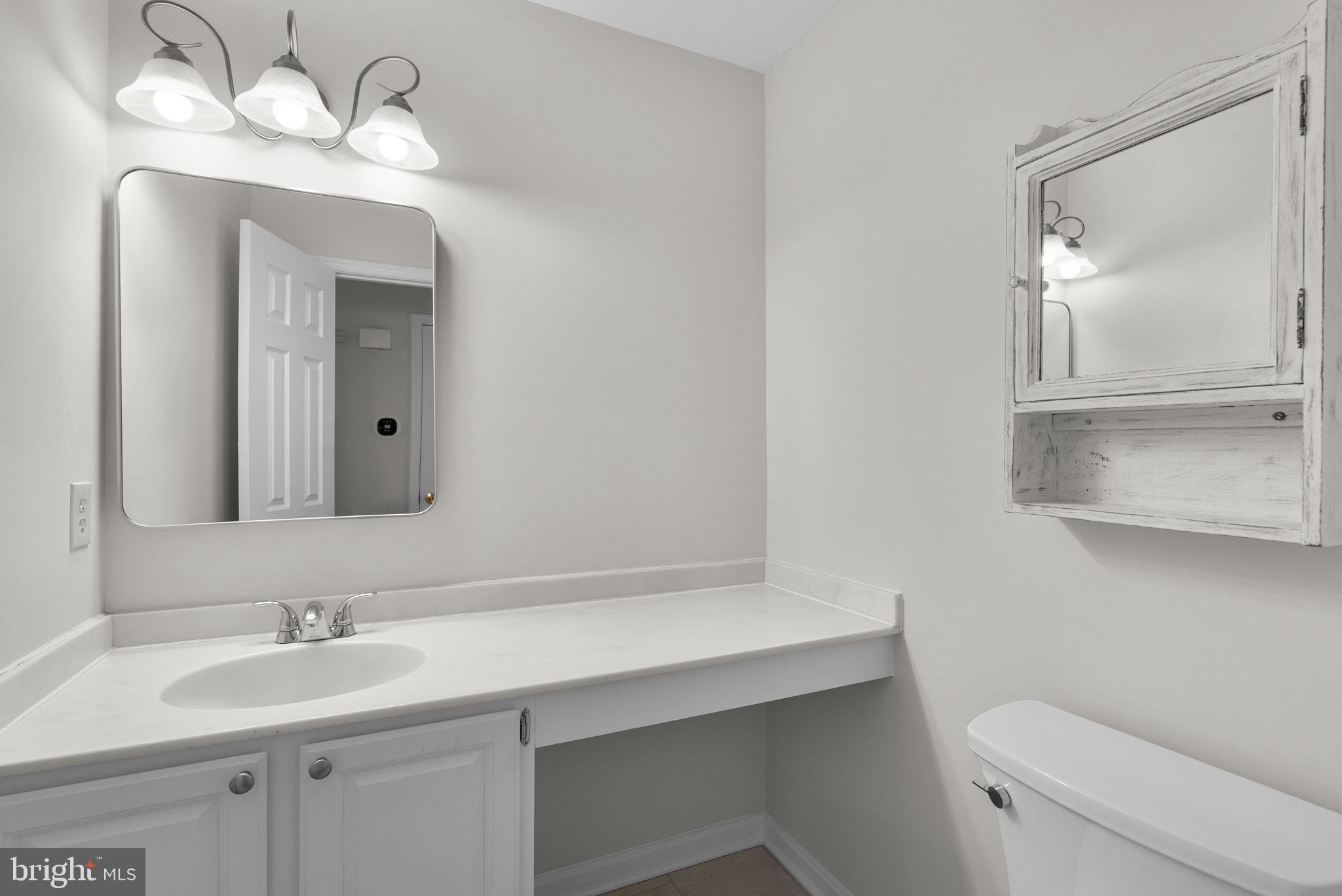 14724 Harvest Lane Silver Spring, MD 20905 - Photo 25 of 53 a bathroom with a sink a toilet and a mirror