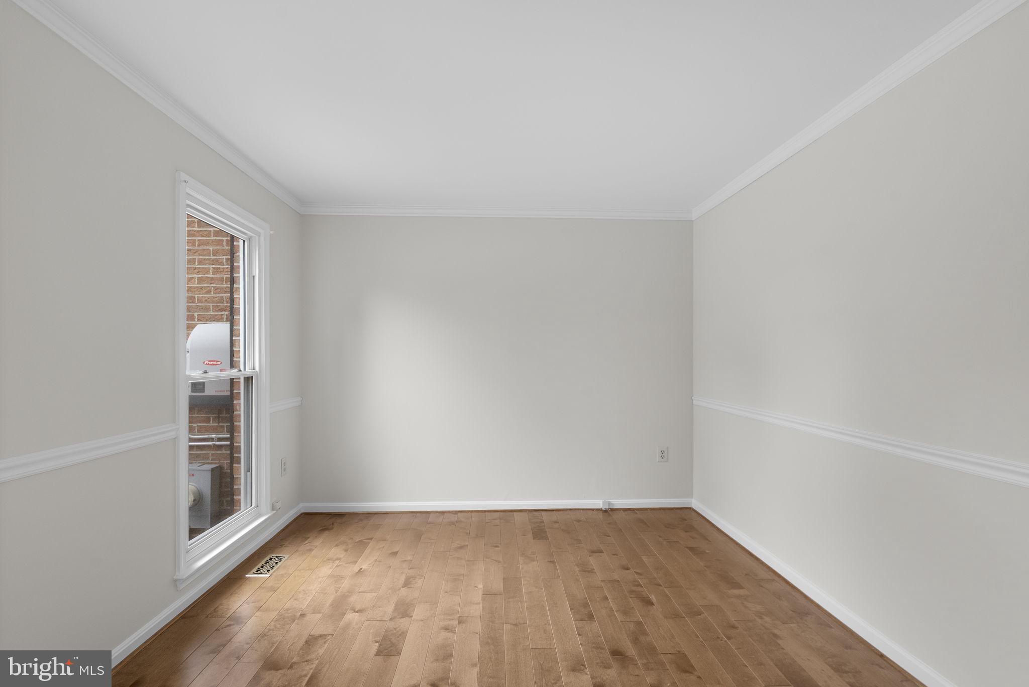 14724 Harvest Lane Silver Spring, MD 20905 - Photo 27 of 53 an empty room with wooden floor and windows