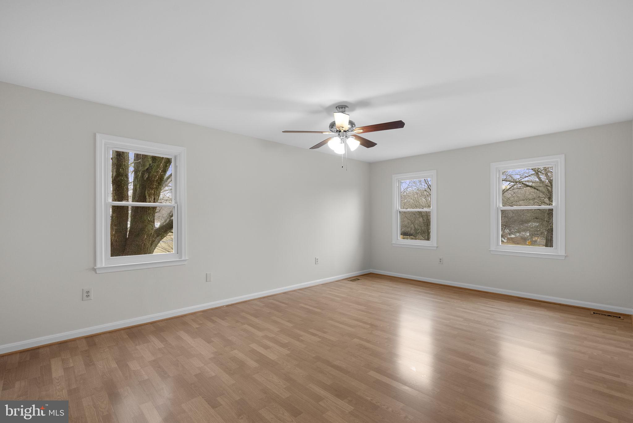 14724 Harvest Lane Silver Spring, MD 20905 - Photo 30 of 53 a view of an empty room with a window and wooden floor