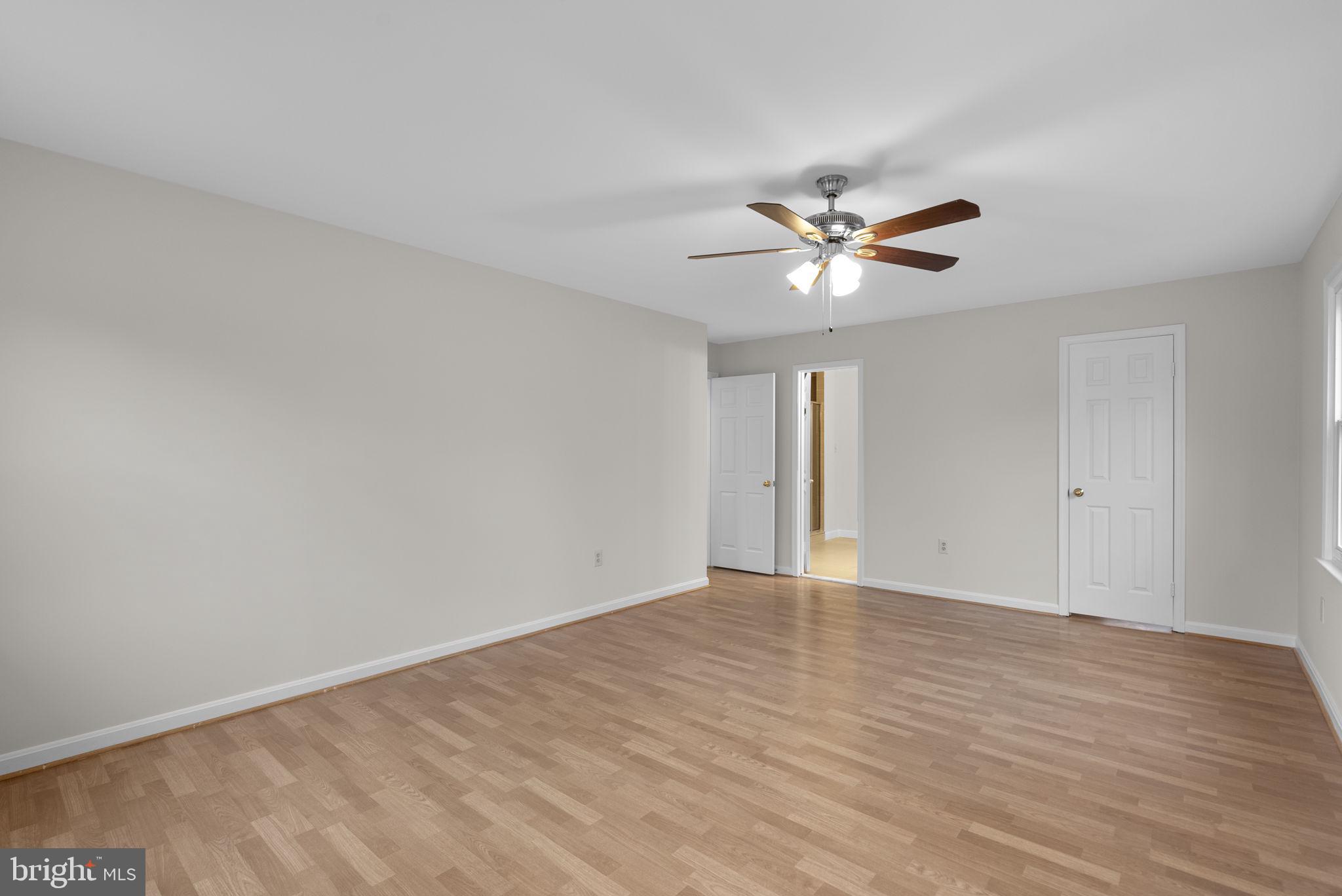 14724 Harvest Lane Silver Spring, MD 20905 - Photo 31 of 53 a view of an empty room with a ceiling fan and window