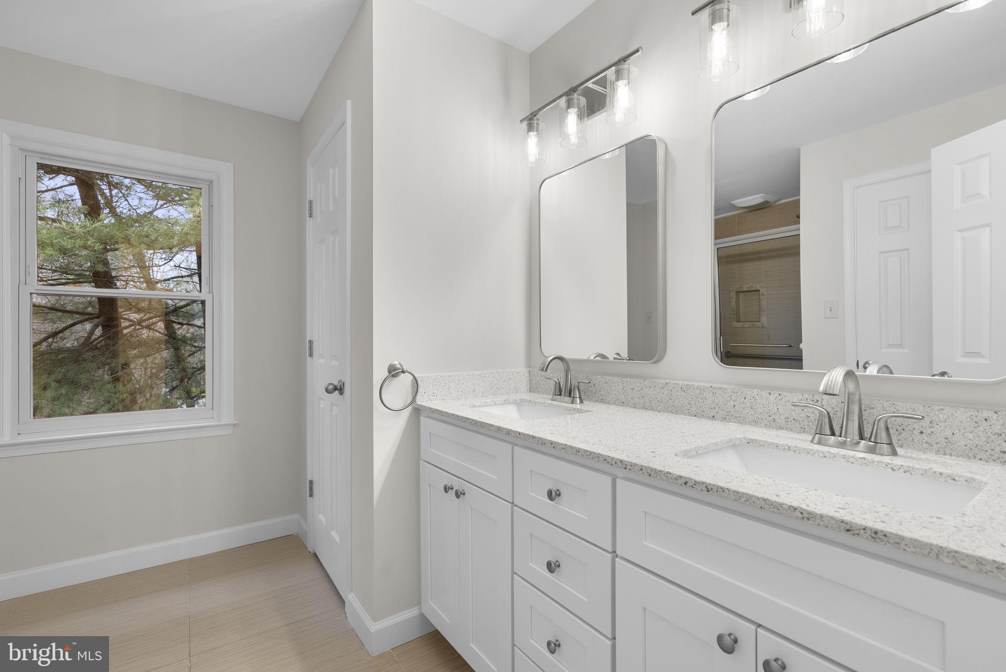 14724 Harvest Lane Silver Spring, MD 20905 - Photo 32 of 53 a en suite bathroom with a granite countertop sink mirror and window