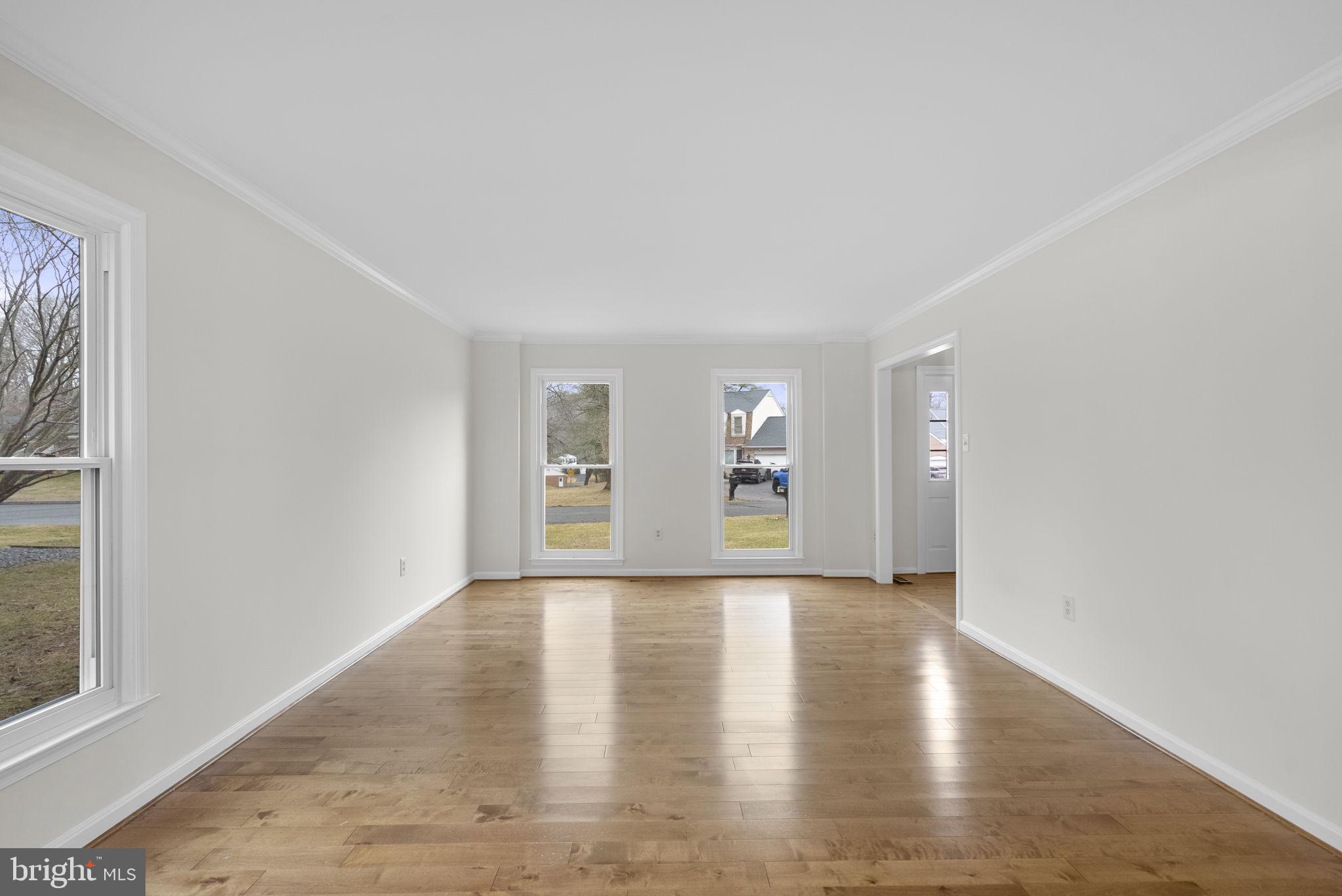 14724 Harvest Lane Silver Spring, MD 20905 - Photo 6 of 53 a view of an empty room with a window and wooden floor