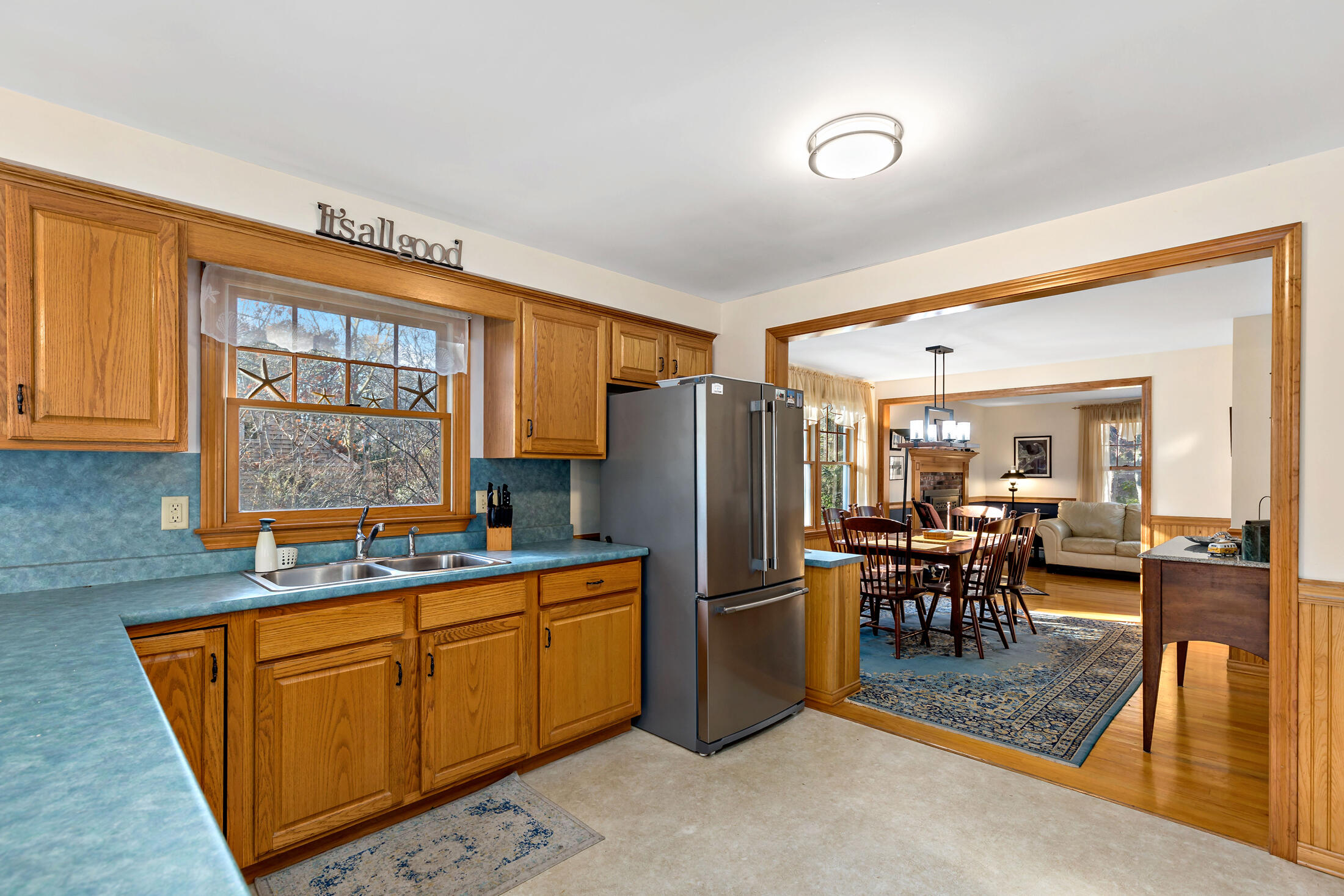25 Forrest Avenue Eastham, MA 02642 - Photo 14 of 46 a kitchen with stainless steel appliances granite countertop a refrigerator a sink a dining table and chairs
