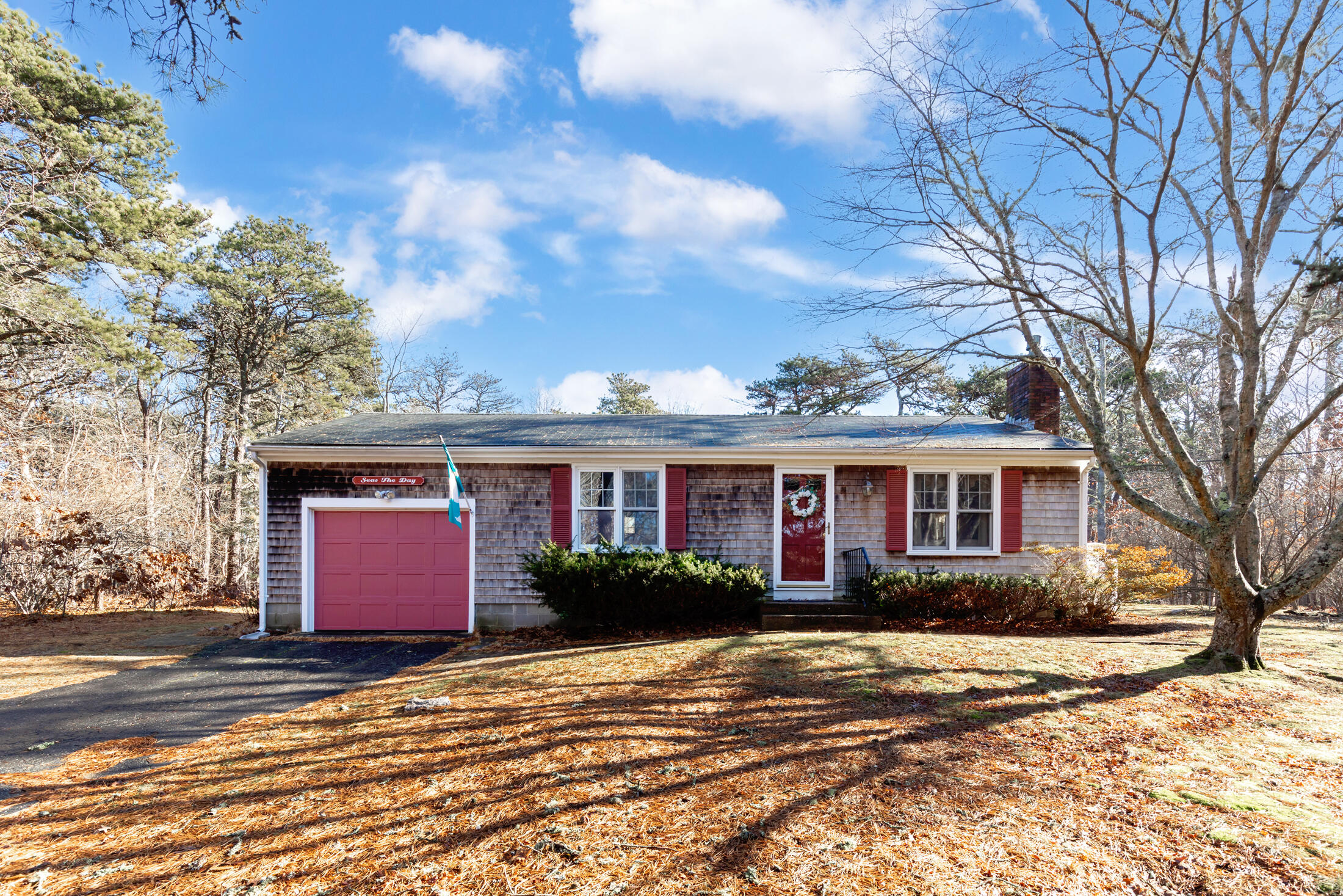 25 Forrest Avenue Eastham, MA 02642 - Photo 2 of 46 a front view of a house with a yard and potted plants