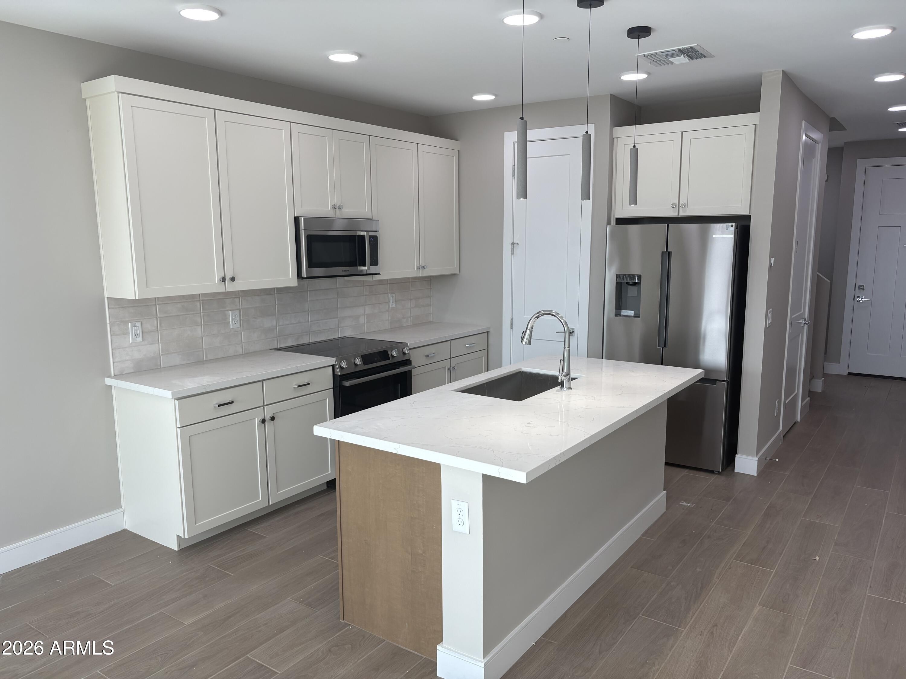 1017 East Pasadena Avenue Phoenix, AZ 85014 - Photo 2 of 11 a kitchen that has a sink a refrigerator and a stove top oven