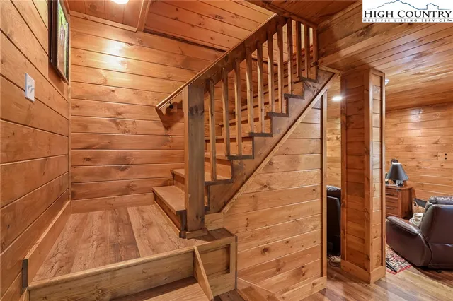 a living room with furniture wooden floor and wall paintings