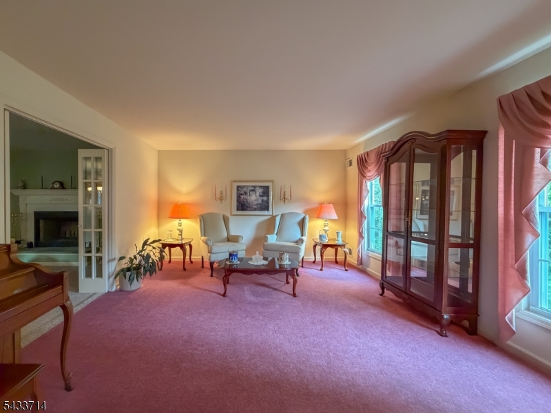 29 Lark Lane Oak Ridge, NJ 07438 - Photo 10 of 26 a living room with furniture a fireplace and a flat screen tv