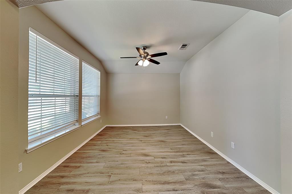 7016 Raintree Way Denton, TX 76210 - Photo 6 of 18 wooden floor in an empty room with a window