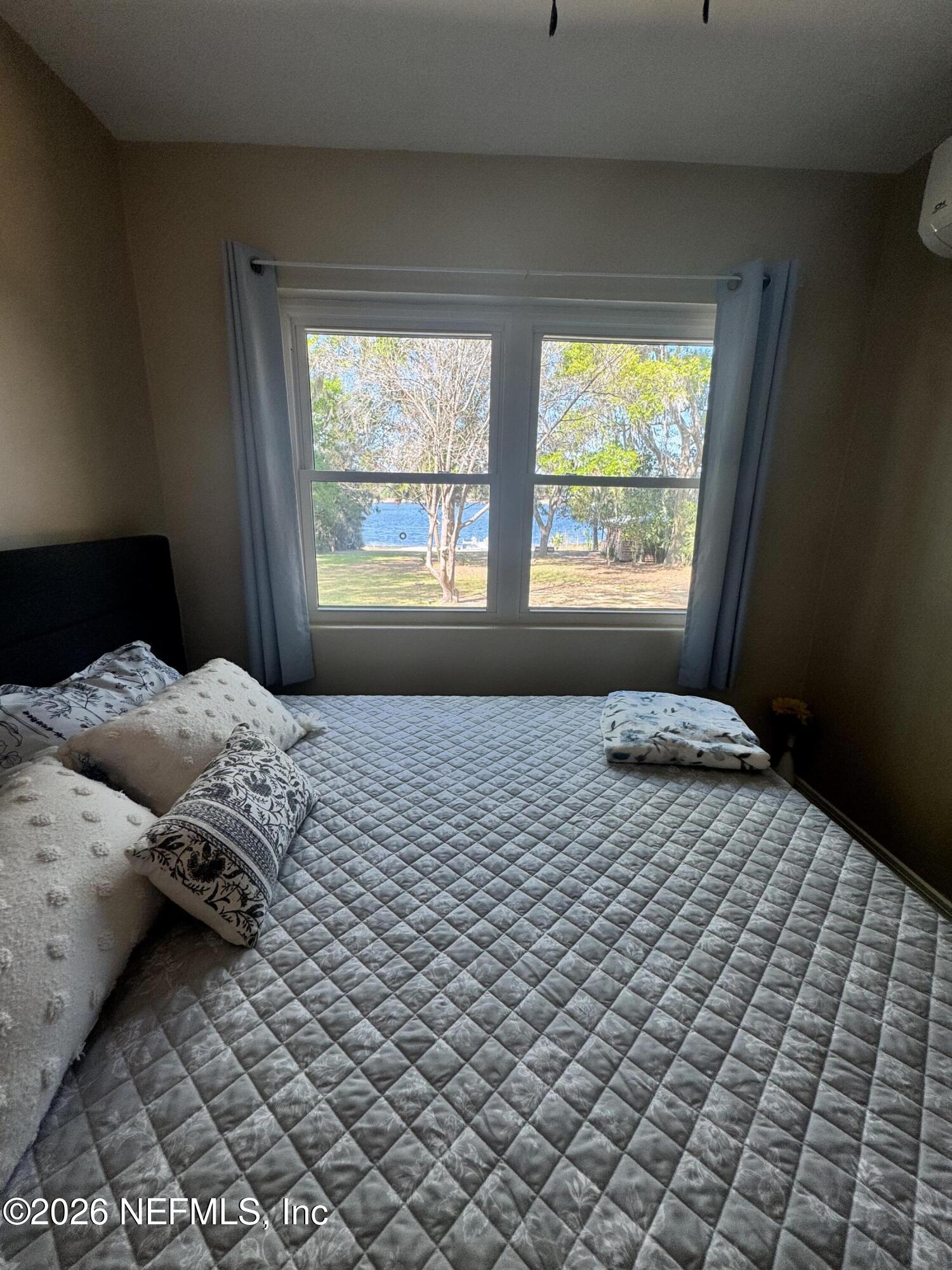 113 Stock Avenue Interlachen, FL 32148 - Photo 17 of 50 a bedroom with a bed and a window