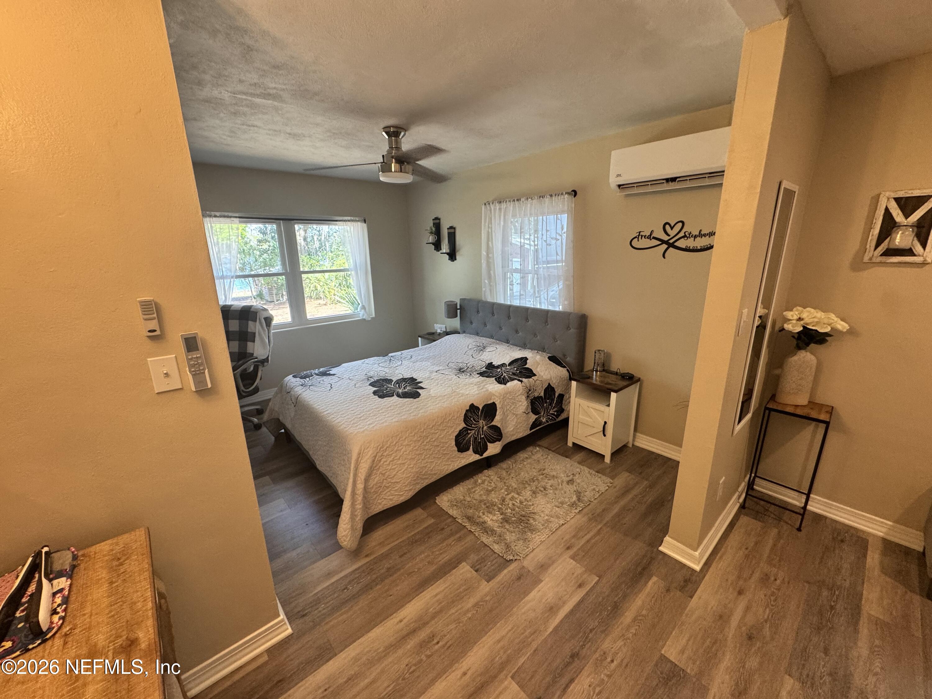 113 Stock Avenue Interlachen, FL 32148 - Photo 20 of 50 a bedroom with a bed wooden floor and window