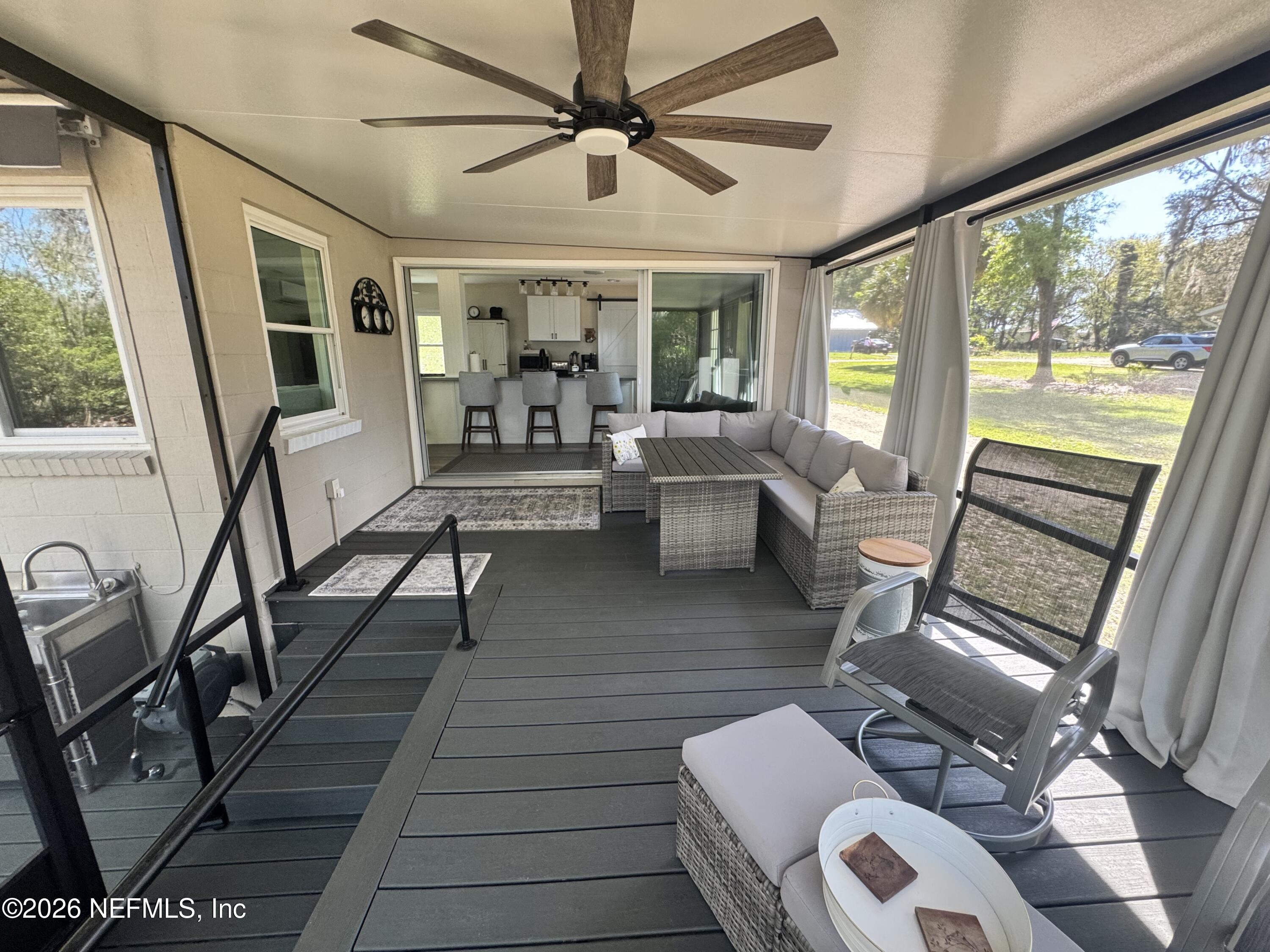 113 Stock Avenue Interlachen, FL 32148 - Photo 27 of 50 a living room with furniture and a large window